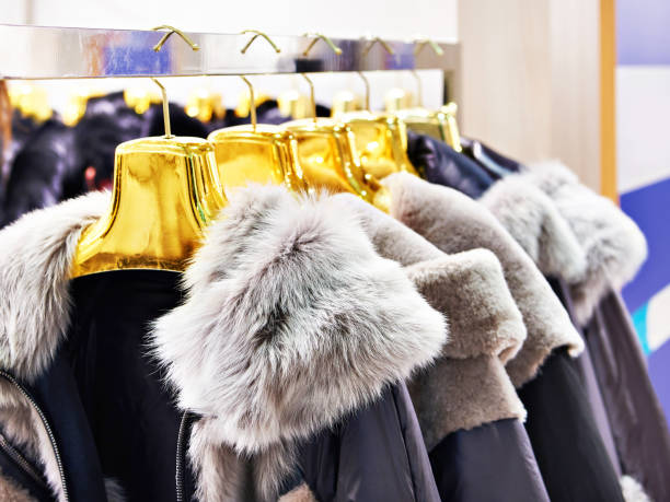 istock Winter jackets with grey fur collars in clothing store 1304927253