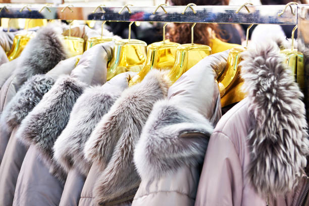 istock Winter jackets with grey fur collars in clothing store 1304927413