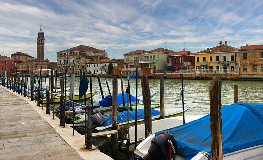 Murano, Italy, April 2, 2016: View of the Canal Grande di Murano on a spring afternoon. The entire Venetian Lagoon is listed as UNESCO World Heritage Site.