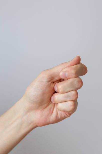 istock Gesture and sign, hand holds something on a light background 1304930465