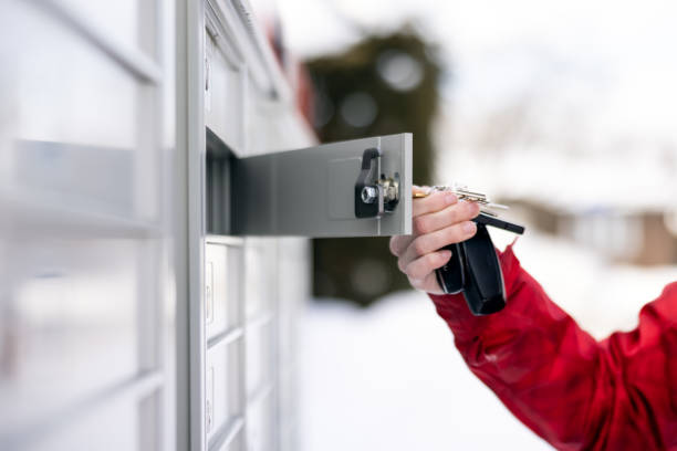 Woman Picking up the Mail at Postal Mailbox During Winter Season