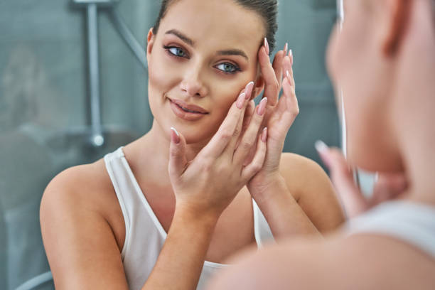 istock Woman looking on reflection in the mirror after shower 1304932005