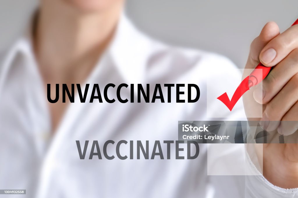 Woman choosing to be unvaccinated Woman making a check mark to be unvaccinated on the white visual board. Vaccination Stock Photo