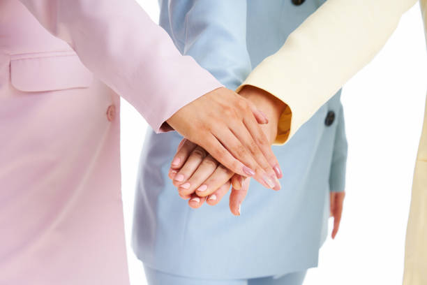 istock Three women in pastel suits posing over white background 1304932832