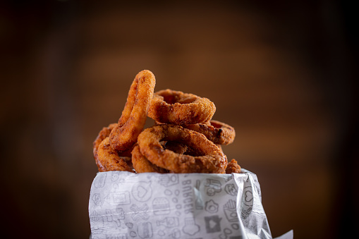 Onion rings snacks in a wooden background