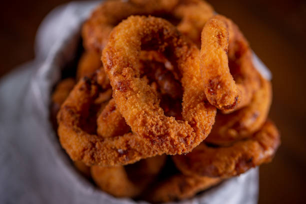 istock Onion rings snacks in a wooden background 1304933194