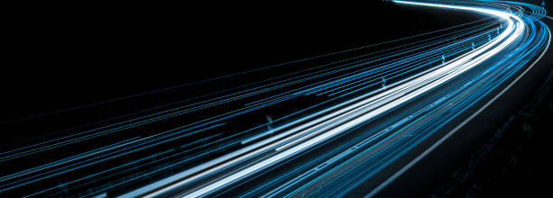 istock blue car lights at night. long exposure 1304933335