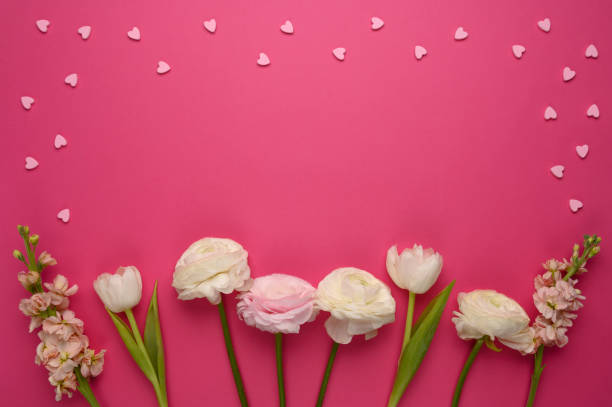 istock Romantic composition frame with hearts and beautiful spring flowers on pink background. Valentine's, women's, mother's day, love concept. 1304934231