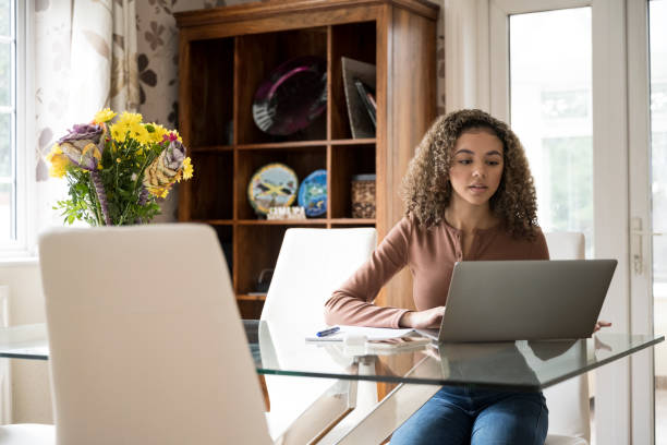 istock Female high school student working on laptop at home 1304935113