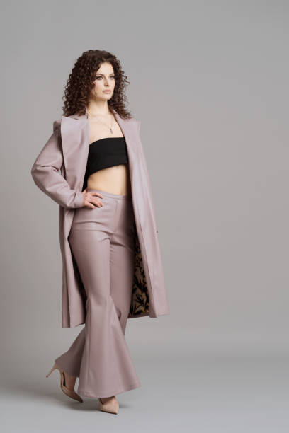 istock Woman in leather stylish clothes on studio gray background 1304935286