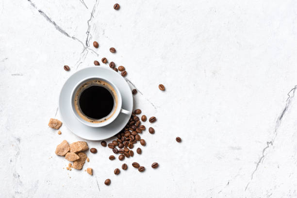 istock Black coffee in white cup with cane lump sugar 1304935376