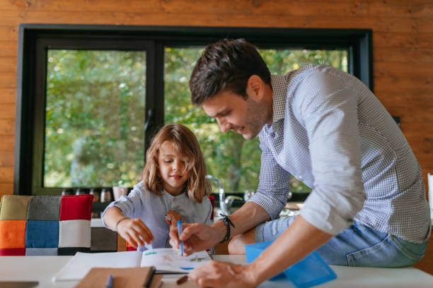 istock Father and son having bonding time at home and drawing together 1304935435