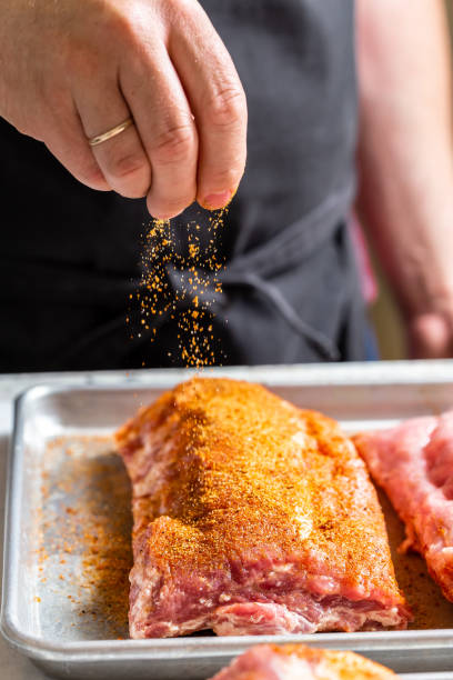 istock Chef puts spices on the raw piece of meat 1304935619
