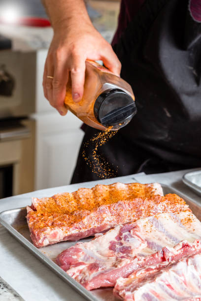 istock Chef puts spices on the raw piece of meat 1304935625