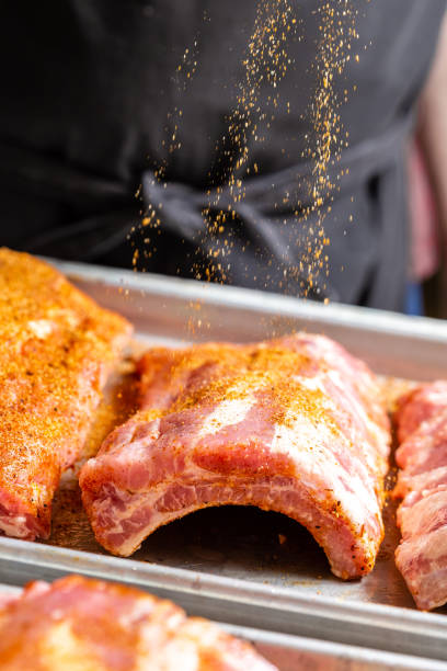 istock Chef puts spices on the raw piece of meat 1304935656