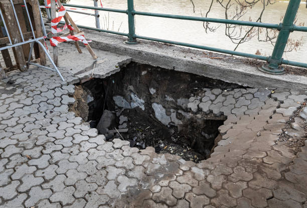 istock Deep hole in pedestrian sidewalk area 1304935674