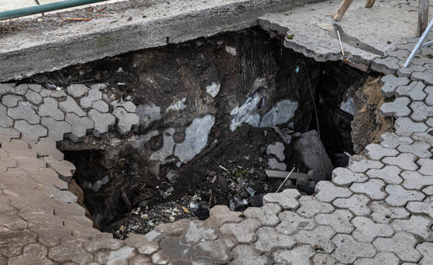 istock Deep hole in pedestrian sidewalk area 1304935881