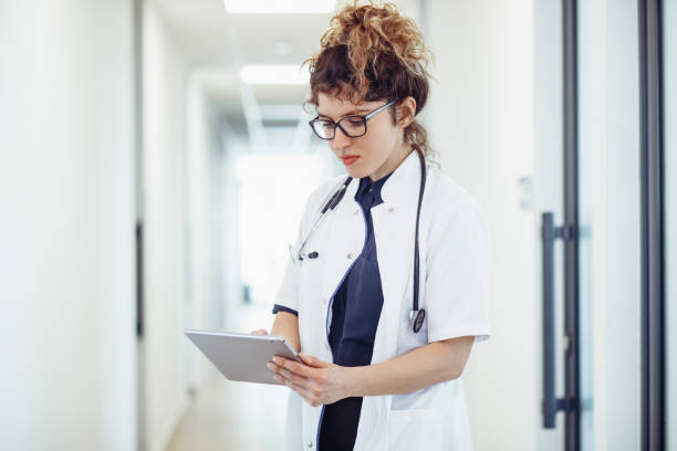 istock Female doctor talking with colleagues through a video call using tablet. Doctor talking with patient through video call using tablet. 1304936613