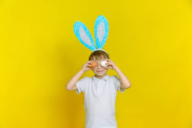 istock Cute happy baby boy with easter eggs and bunny ears 1304937783