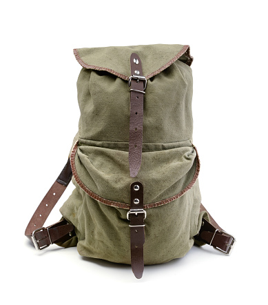 Small old military canvas backpack isolated on white.