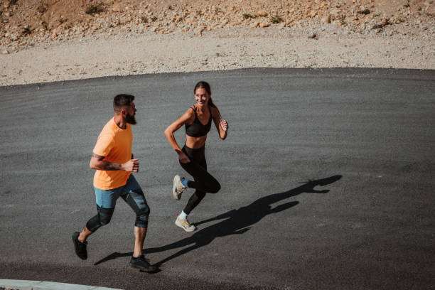 istock Athlete couple running on the road 1304938349