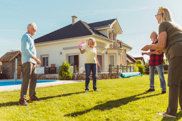 istock Senior friends having fun playing toss and catch 1304939050