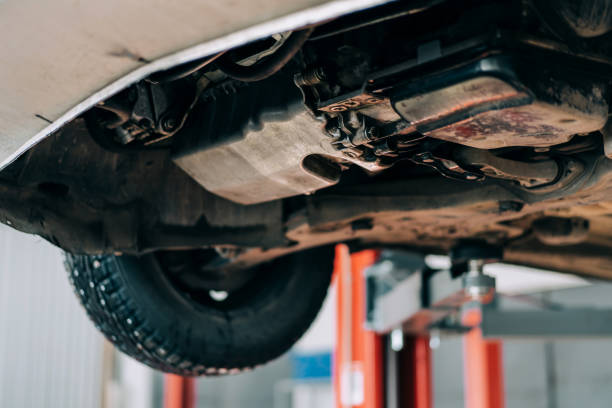 istock Internal combustion engine bottom view. The machine is lifted on a car lift for repair 1304939097