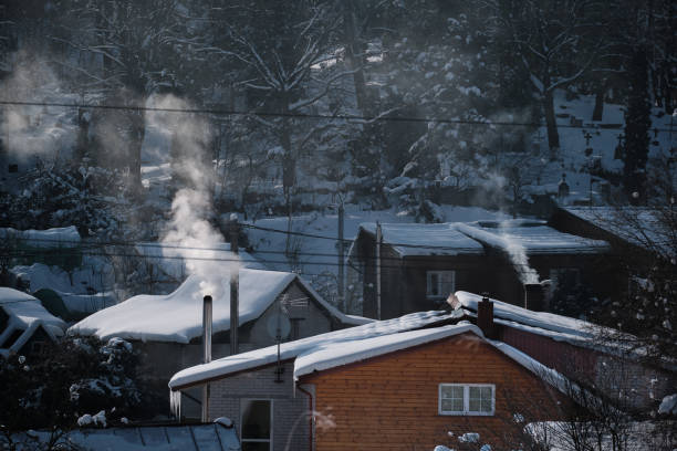istock winter scenery with smoke coming from house chimneys 1304940779