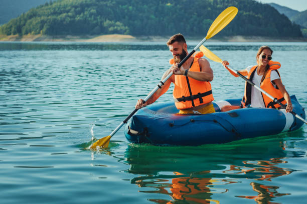 istock Lovely young couple on a kayak rowing 1304941311