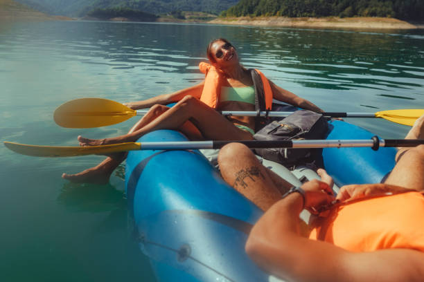 istock Paddling young couple on the river 1304941906