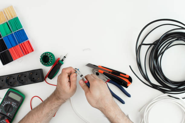 istock electrician works with a tool on a white background 1304942605