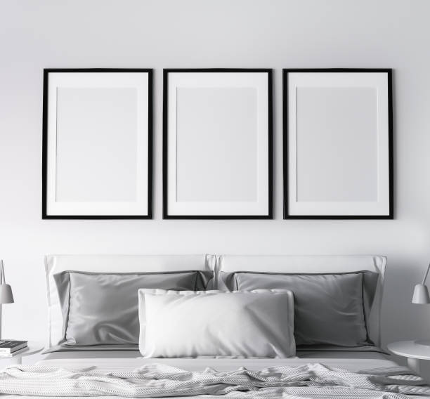 istock Frame mockup in modern bedroom design, three black frames on bright white wall 1304942694