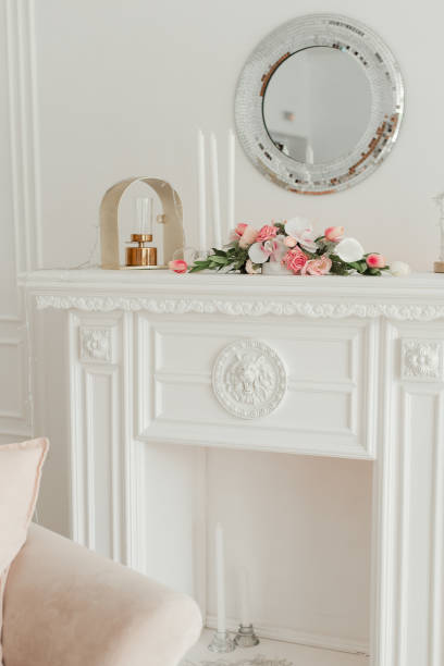 istock bookcase, white table for indoor plants. fresh flowers in the interior. 1304943536