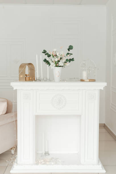 istock white vase with artificial flowers on vintage table. 1304943575