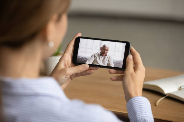 istock Woman talk on video call with mature dad 1304943831