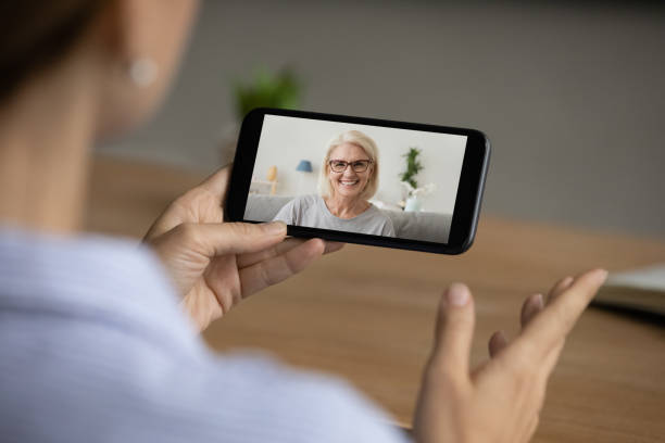 istock Woman have webcam call on cell with mom 1304943833