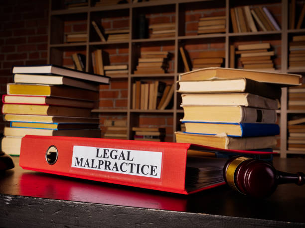 istock Documents about legal malpractice in the red folder. 1304944154