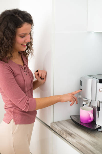 istock Woman making coffee in the kitchen 1304944242