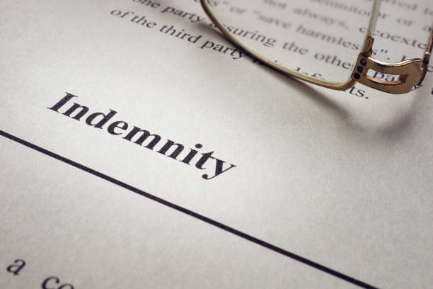 istock Indemnity word on the old sheet and glasses. 1304944872