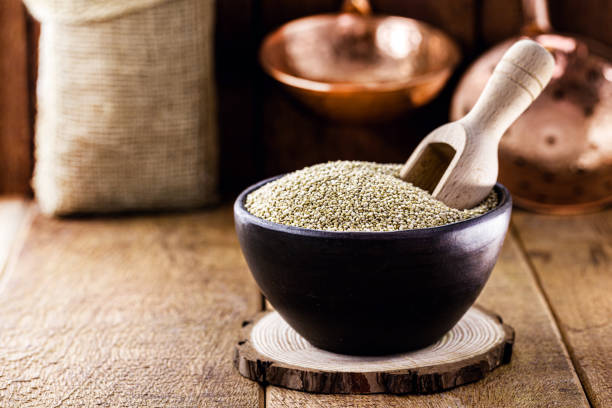 quinoa in handmade clay pot. grain superfood, vegan food - quinoa spoon wood photography imagens e fotografias de stock