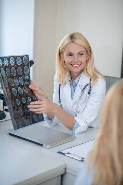 istock Joyful doctor showing MRT scan to patient 1304947204
