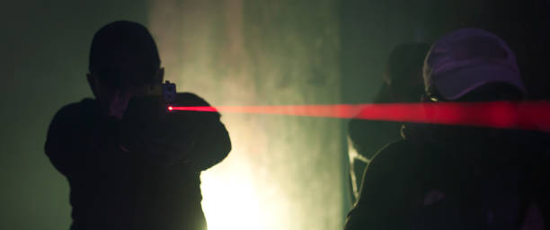 istock Army soldier in action aiming at weapon laser sight optics 1304947421