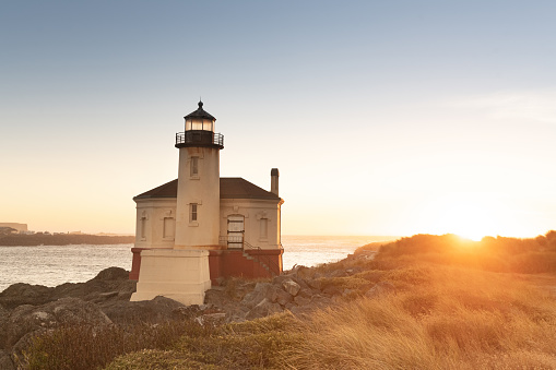 This photograph is of the Coquille River Lighthouse at Bullards Beach State Park on the Oregon Coast at sunset.