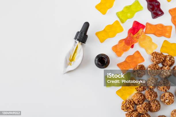Gummy Bears Cannabis Cookies And Cbd Oil Dropper In White Backdrop Stock Photo - Download Image Now
