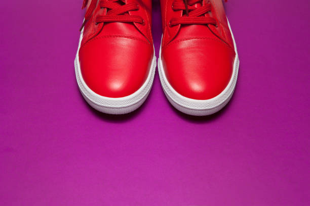 istock One sport red sneakers on purple background 1304953529