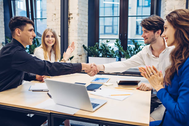 istock businessmen shaking hands in office 1304956265