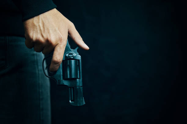 istock Black revolver with drum in man's hand. 1304958553