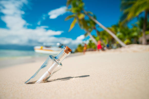 istock Bottle with a message on a tropical island beach. 1304958763