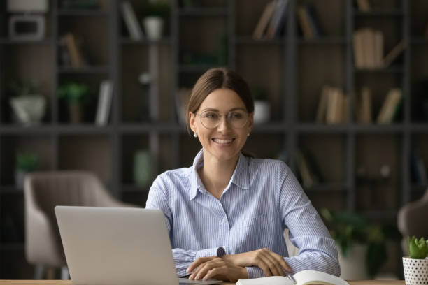 istock Smiling Caucasian woman work on computer in office 1304963535