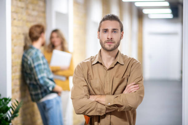 istock Young bearded man standing in the corridor and looking serious 1304963837